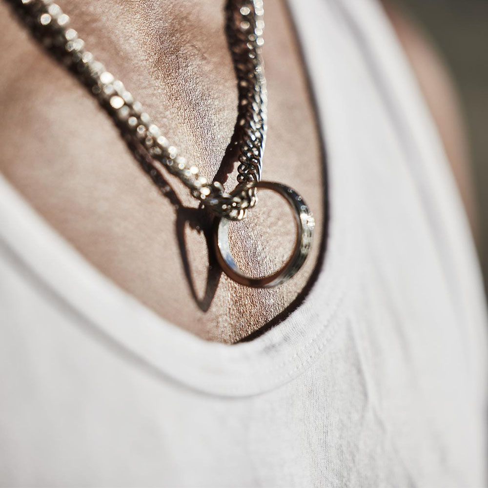 תכשיטי ים אור - גבר עונד שרשראת כסף עם טבעת תלויה כתליון